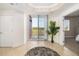 Bright foyer featuring tile floors, balcony access, and views to the exterior at 611 Riviera Dunes Way # 108, Palmetto, FL 34221