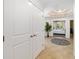 Inviting hallway with tile flooring leading to a bedroom at 611 Riviera Dunes Way # 108, Palmetto, FL 34221