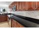 Modern kitchen featuring stainless steel appliances, dark countertops and backsplash at 611 Riviera Dunes Way # 108, Palmetto, FL 34221
