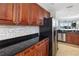 Kitchen featuring stainless steel appliances, granite counters and wooden cabinetry at 611 Riviera Dunes Way # 108, Palmetto, FL 34221