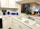 Clean kitchen with double sink, ample counter space and white cabinets at 6503 Stone River Rd # 109, Bradenton, FL 34203