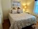 Bright bedroom featuring a double bed, nightstand, and wood floors at 6503 Stone River Rd # 109, Bradenton, FL 34203
