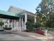 Clubhouse entrance with columns, landscaping, and accessible ramp at 6503 Stone River Rd # 109, Bradenton, FL 34203