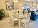 Bright dining area with glass table and six chairs, adjacent to living room at 6503 Stone River Rd # 109, Bradenton, FL 34203