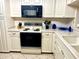 Well-equipped kitchen featuring a modern stove and microwave at 6503 Stone River Rd # 109, Bradenton, FL 34203