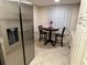Bright kitchen nook with breakfast table and chairs, adjacent to stainless steel refrigerator at 6503 Stone River Rd # 109, Bradenton, FL 34203