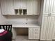 White kitchen cabinets and a built-in desk at 6503 Stone River Rd # 109, Bradenton, FL 34203