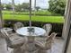 Screened patio with glass table and chairs, overlooking lush greenery at 6503 Stone River Rd # 109, Bradenton, FL 34203