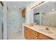 Well-appointed bathroom with dual sinks, shower, and laundry closet at 845 Wexford Blvd # 845, Venice, FL 34293