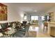 Open concept dining room with a glass table, gray chairs and living room view at 15607 Sunny Day Dr, Bradenton, FL 34211