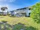 Rear view of the property showing a grassy yard at 1521 Pleasant Rd # A24, Bradenton, FL 34207