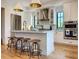 Modern kitchen featuring white cabinetry, a large island, and stainless steel appliances at 590 Hibiscus Way, Longboat Key, FL 34228