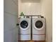 Bright laundry room with washer, dryer, and cabinets at 590 Hibiscus Way, Longboat Key, FL 34228