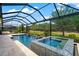 Resort-style pool and spa with tiled accents at 5565 Long Shore Loop, Sarasota, FL 34238
