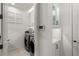 Clean laundry room with washer, dryer, and cabinets at 5565 Long Shore Loop, Sarasota, FL 34238