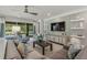 Bright living area with a sectional sofa, built-in shelving, and large windows at 5565 Long Shore Loop, Sarasota, FL 34238