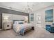 Luxurious main bedroom with a tufted headboard and ensuite bathroom access at 5565 Long Shore Loop, Sarasota, FL 34238
