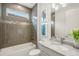 Small bathroom with gray tile and modern vanity at 5565 Long Shore Loop, Sarasota, FL 34238