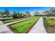 Bocce ball courts with lush green turf and landscaping at 5565 Long Shore Loop, Sarasota, FL 34238