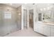 Spa-like bathroom with dual vanities and a large walk-in shower at 5565 Long Shore Loop, Sarasota, FL 34238