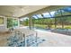Covered patio overlooking a refreshing pool and spa at 5565 Long Shore Loop, Sarasota, FL 34238