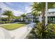 Community clubhouse with palm trees and walking path at 5565 Long Shore Loop, Sarasota, FL 34238