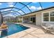 Covered patio overlooks a refreshing pool at 5565 Long Shore Loop, Sarasota, FL 34238