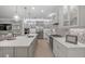 Modern kitchen features stainless steel appliances and a large island with quartz countertops at 5565 Long Shore Loop, Sarasota, FL 34238