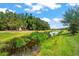 Peaceful waterfront view with lush landscaping at 5565 Long Shore Loop, Sarasota, FL 34238