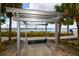 Park bench under pergola overlooking waterfront with bridge in distance at 210 3Rd W St # 8407, Bradenton, FL 34205