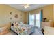 Bright bedroom with a floral comforter, dresser, and a workspace at 210 3Rd W St # 8407, Bradenton, FL 34205