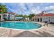 Community pool with plenty of lounge chairs and a covered seating area at 210 3Rd W St # 8407, Bradenton, FL 34205
