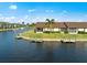 Waterfront property featuring a private dock and lush landscaping at 3920 Bal Harbor Blvd # D8, Punta Gorda, FL 33950