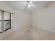 Simple bedroom with a ceiling fan and window offering natural light at 3920 Bal Harbor Blvd # D8, Punta Gorda, FL 33950