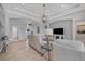 Open concept living area with neutral decor, high ceilings and views of kitchen and entryway at 13853 Siena Loop, Lakewood Ranch, FL 34202