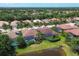 Aerial view of community, showcasing numerous homes and a lake at 13853 Siena Loop, Lakewood Ranch, FL 34202