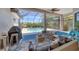 Relaxing screened pool area with patio furniture and grill at 13853 Siena Loop, Lakewood Ranch, FL 34202
