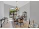 Elegant dining room with chandelier and large windows at 13853 Siena Loop, Lakewood Ranch, FL 34202