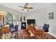 Home office features a large desk, comfortable seating, and a hardwood floor at 13853 Siena Loop, Lakewood Ranch, FL 34202