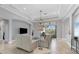 Open living room with recessed lighting, neutral decor and access to pool area at 13853 Siena Loop, Lakewood Ranch, FL 34202