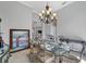 Formal dining room showcasing a glass-top table and ornate chairs at 13853 Siena Loop, Lakewood Ranch, FL 34202