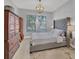 Spacious bedroom with plush bed, large dresser, and light hardwood floors at 13853 Siena Loop, Lakewood Ranch, FL 34202