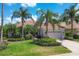 Luxury home with a tile roof, lush landscaping, and a paved driveway at 13853 Siena Loop, Lakewood Ranch, FL 34202