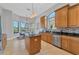 Modern kitchen with an island, wood cabinets, and a breakfast nook at 13853 Siena Loop, Lakewood Ranch, FL 34202