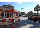 Relaxing patio area with seating and red umbrellas at 13853 Siena Loop, Lakewood Ranch, FL 34202