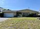 Charming one-story home featuring an attached garage and a well-maintained front yard at 6613 Blue Heron S Dr, St Petersburg, FL 33707
