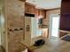 Kitchen with tiled backsplash, an island with granite countertop, and appliances at 6613 Blue Heron S Dr, St Petersburg, FL 33707
