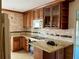 A well-lit kitchen features granite countertops, stainless appliances, tile backsplash, and wood cabinets at 6613 Blue Heron S Dr, St Petersburg, FL 33707
