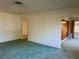 Open living room featuring carpeted floors, ample natural light, and a neutral color palette at 6613 Blue Heron S Dr, St Petersburg, FL 33707