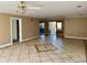 Spacious living room with tile flooring, ceiling fans, and a view of the front door at 6613 Blue Heron S Dr, St Petersburg, FL 33707